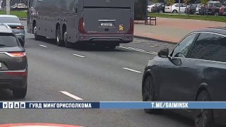 Passenger sticks out of BMW sunroof while driving on Dzerzhinskogo Avenue