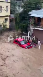 In Mexico floods, family nearly swept away while clinging to car